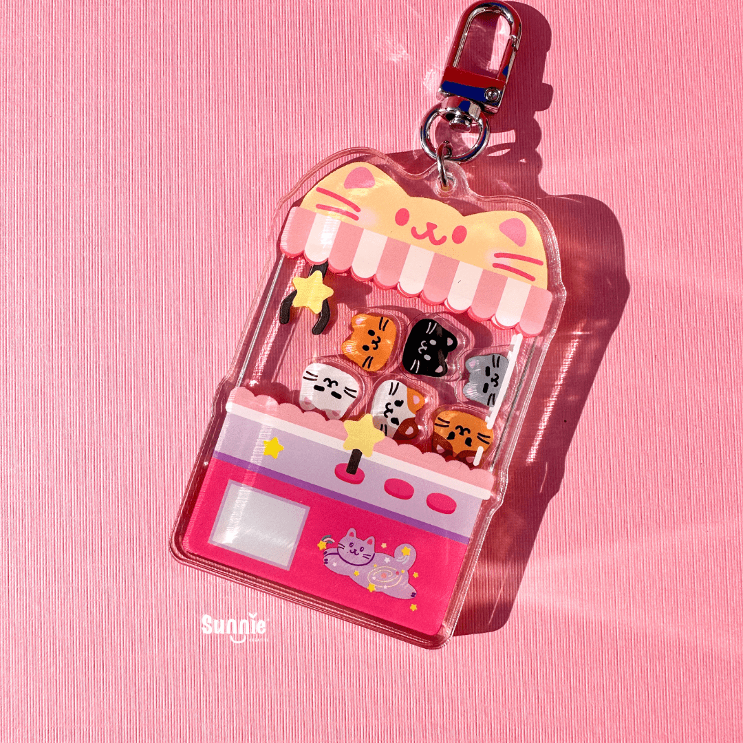 Cat Claw machine with 6 different color cats inside shaker keychain